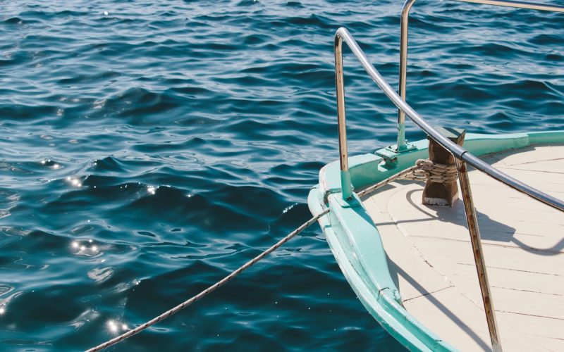 A closeup shot of a ship sailing in the calm sea on a beautiful day