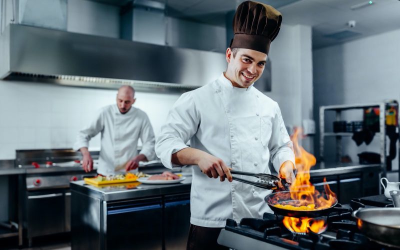 Cropped shot of a young male chef preparing the meal in a professional kitchen